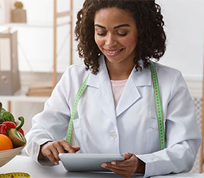 woman planning meals for client on tablet