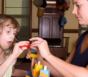 therapist working with child with disability