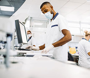 man in lab entering test result data