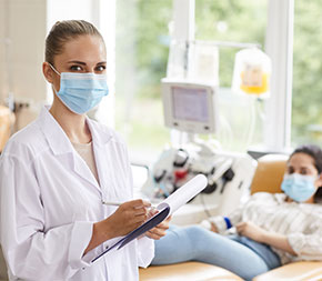 woman taking info from woman giving blood
