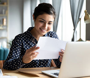smiling woman reading papers