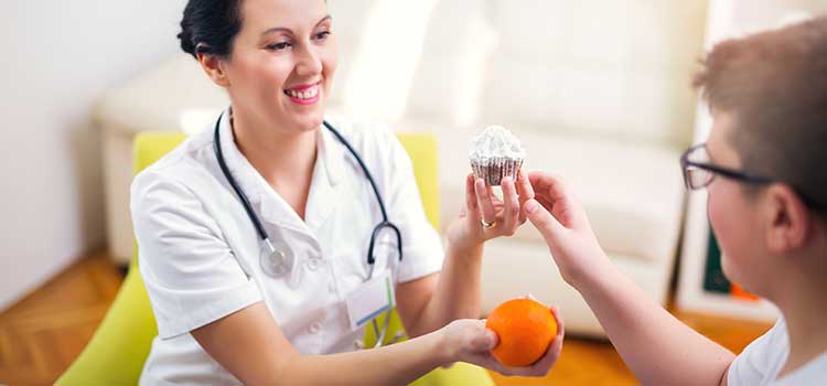 pediatric nutritionist discussing food program with young boy