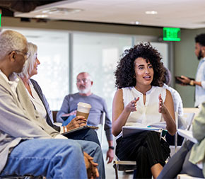 professional leading seated group in discussion