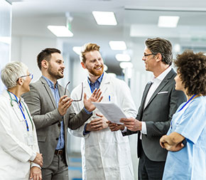 hospital team confers in corridor