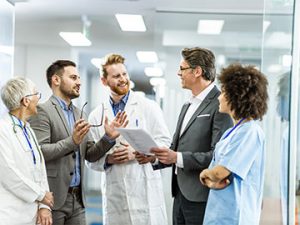 hospital team confers in corridor