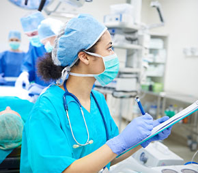 medial assistant recording vitals in operating room