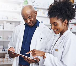 pharmacist and technician looking at prescription order