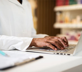 hands typing on computer keyboard