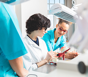 teacher works with dental assistant student