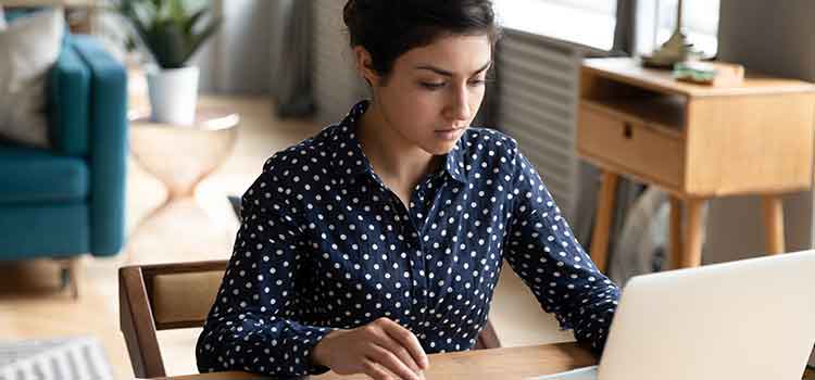 woman on laptop researching medical billing and coding programs