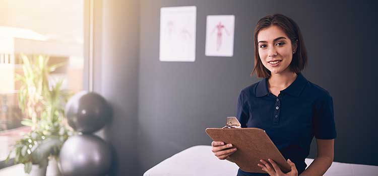 physical therapy student holding clipboard