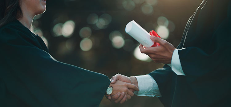 close up of radiology tech department leader bestowing diploma on new graduate