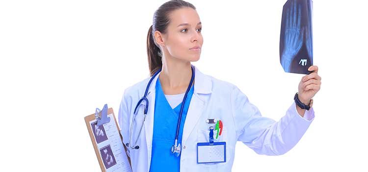 radiology tech graduate holding xray film