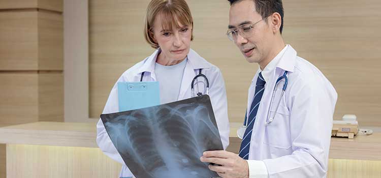 two technicians consulting over xray