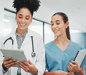 nurse shows medical assistant patient file on tablet