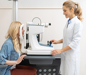 optometric technician performs vision test on patient