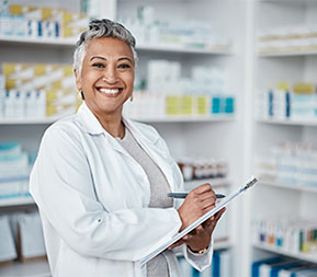 female healthcare manager checks her clipboard in a pharmaceutical office