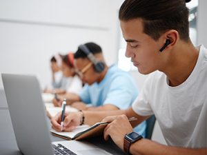healthcare students taking notes on a lecture in their class