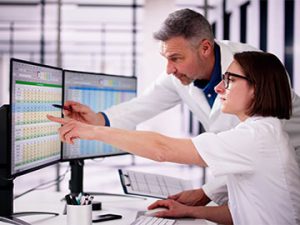 medical billing and coding student gets tips about codes from instructor