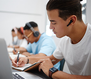 healthcare students taking notes on a lecture in their class