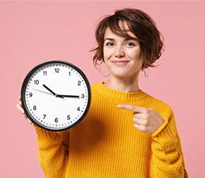 healthcare student points to clock signifying time management