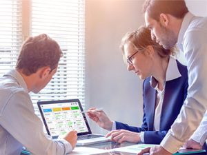 healthcare administrators look over agile scrum board to provide lean management