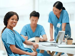 medical coding students practice coding exercises at a table