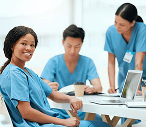medical coding students practice coding exercises at a table