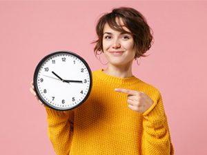 healthcare student points to clock signifying time management