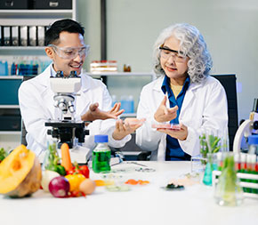 a pair of research dietitians work in a lab and test food samples