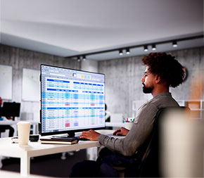 medical coder works at a computer and bundles medical code reports