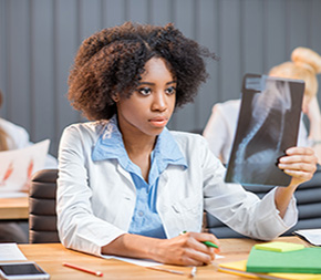 medical assisting student examines x-ray for challenging exam