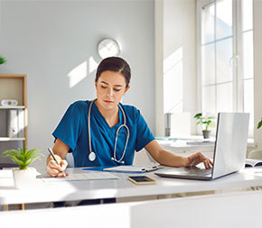 medical assistant student studies on her laptop