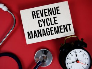 picture of stethoscope, alarm clock, and card with text on it reading revenue cycle management