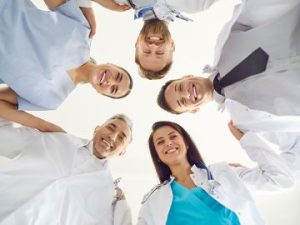 a group of five healthcare students smile down at the camera